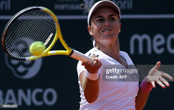 Anabel Garrigues of Spain returns a forehand to Shuai Peng of China during their Estoril Open tennis match at Jamor Stadium, in Estoril, outskirts of...
