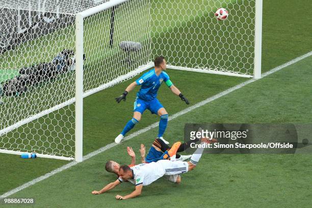 Sergey Ignashevich of Russia scores an own goal to bring the score to 1-0 as he drags Sergio Ramos of Spain down in the box during the 2018 FIFA...