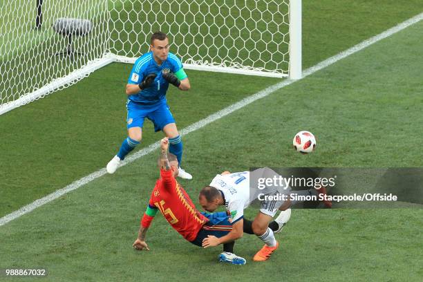 Sergey Ignashevich of Russia scores an own goal to bring the score to 1-0 as he drags Sergio Ramos of Spain down in the box during the 2018 FIFA...