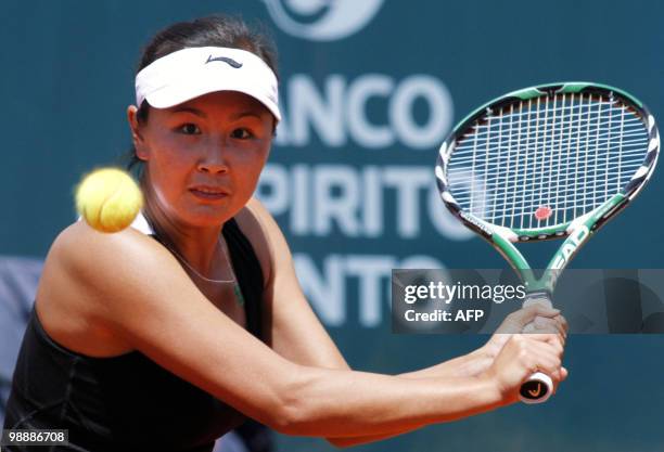 Shuai Peng of China returns the ball to Anabel Garrigues of Spain during their Estoril Open tennis at Jamor Stadium, in Estoril, outskirts of Lisbon,...
