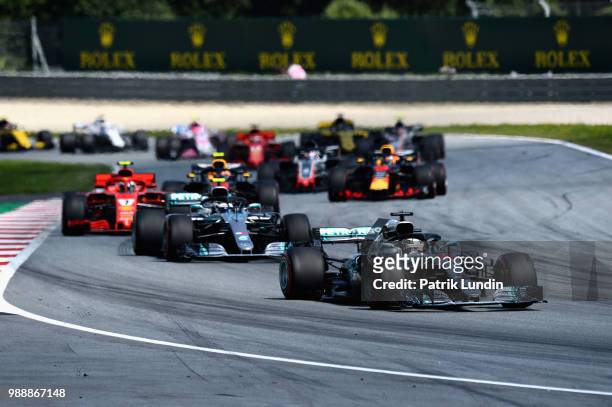 Lewis Hamilton of Great Britain driving the Mercedes AMG Petronas F1 Team Mercedes WO9 leads the field during the Formula One Grand Prix of Austria...
