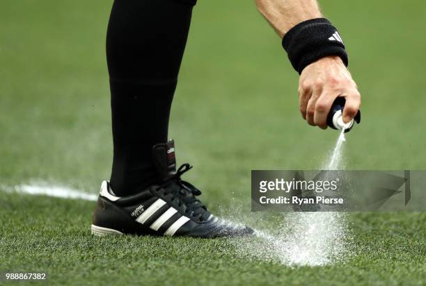 Referee Bjorn Kuipers uses vanishing spray to mark the placement of a free kick during the 2018 FIFA World Cup Russia Round of 16 match between Spain...