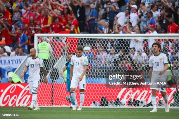 Fedor Kudriashov, Roman Zobnin and Yury Zhirkov of Russia look dejected after Sergey Ignashevich of Russia scored an own goal to make it 1-0 during...