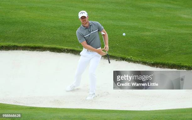 David Horsey of England chips out from a bunker on the 18th hole during day four of the HNA Open de France at Le Golf National on July 1, 2018 in...
