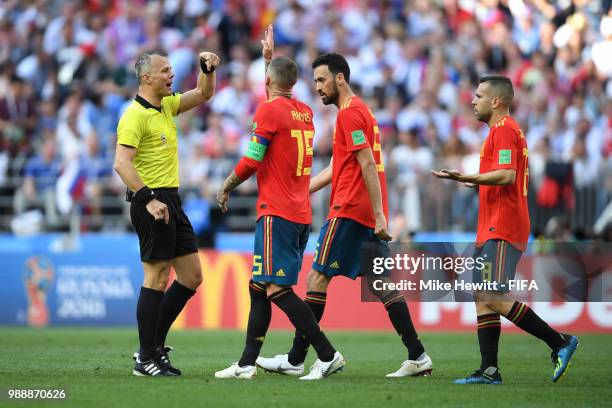 Referee Bjorn Kuipers talks to Sergio Ramos, Sergio Busquets and Jordi Alba of Spain during the 2018 FIFA World Cup Russia Round of 16 match between...