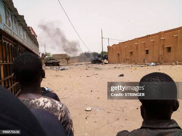 Bystanders watch from afar the scene of an explosion in Gao, northwestern Mali on July 1, 2018. French soldiers operating in troubled northern Mali...