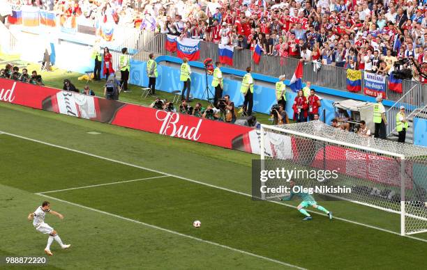 Artem Dzyuba of Russia scores a penalty past David De Gea of Spain for his team's first goal during the 2018 FIFA World Cup Russia Round of 16 match...