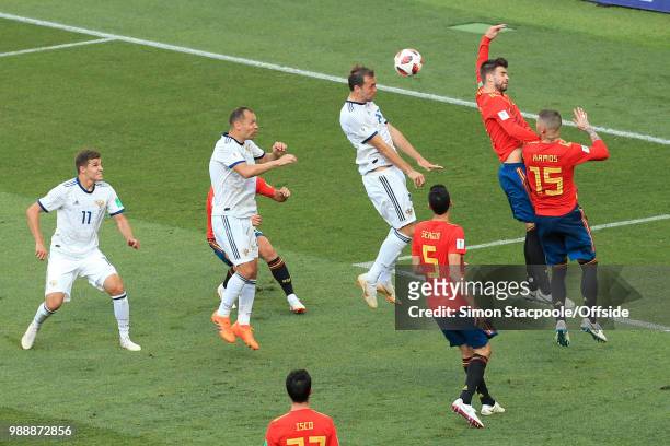 Gerard Pique of Spain gives away a penalty after a header from Artem Dzyuba of Russia connects with his outstretched arm for hand-ball during the...