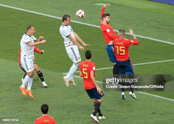 Gerard Pique of Spain gives away a penalty after a header from Artem Dzyuba of Russia connects with his outstretched arm for hand-ball during the...