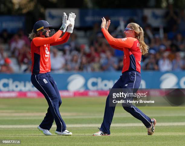 Sophie Ecclestone of England celebrates with Sarah Taylor after taking the wicket of Suzie Bates of New Zealand during the International T20...