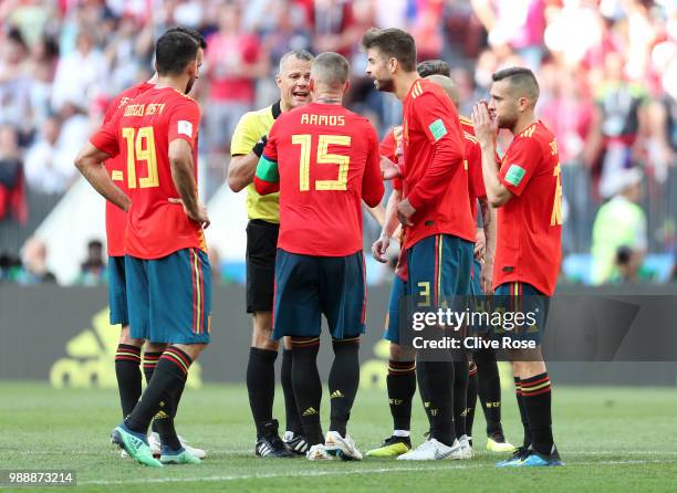 Gerard Pique of Spain of Spain argue with referee Bjorn Kuipers after he awards Russia with a penalty during the 2018 FIFA World Cup Russia Round of...