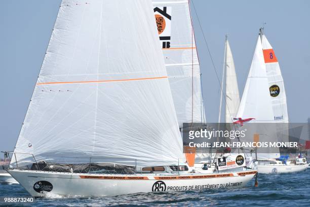 France's Philippe Péché watches the sails on his boat "PRB" as he sets sail from Les Sables d'Olonne Harbour on July 1 at the start of the solo...