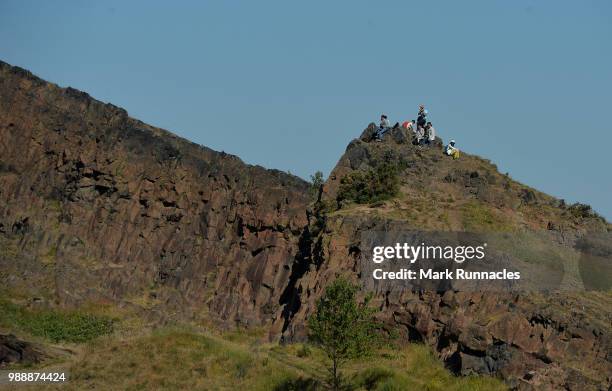 Spectators look on as Athletes compete in the run leg inside Holyrood Park during the IRONMAN 70.3 Edinburgh Triathlon on July 1, 2018 in Edinburgh,...