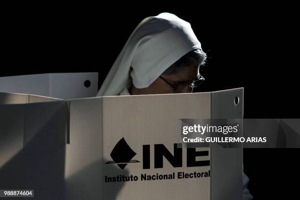 Nun casts her vote during the presidential election at a polling station in Xochimilco, Mexico City on July 1, 2018. Fed up with corruption and...