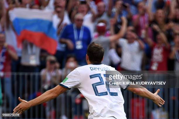 Russia's forward Artem Dzyuba celebrates after scoring their first goal on a penalty kick during the Russia 2018 World Cup round of 16 football match...