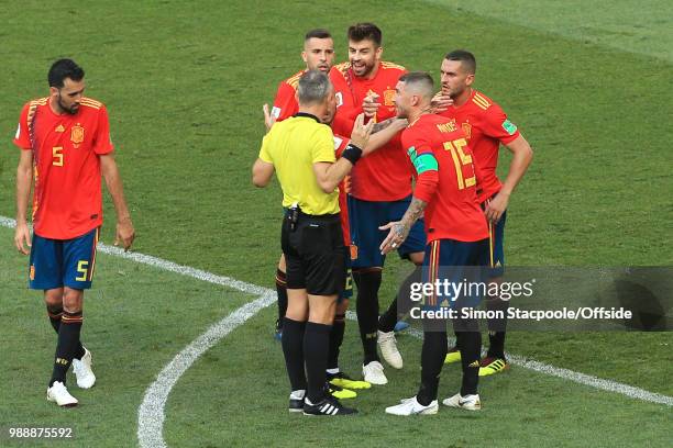 Gerard Pique of Spain argues with referee Bjorn Kuipers after his hand-ball leads to a penalty to Russia during the 2018 FIFA World Cup Russia Round...