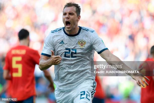 Russia's forward Artem Dzyuba celebrates after shooting a penalty kick and score a goal during the Russia 2018 World Cup round of 16 football match...