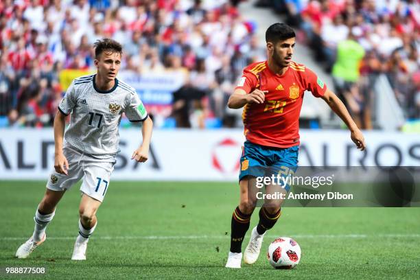 Aleksandr Golovin of Russia and Marco Asensio of Spain during the FIFA World Cup Round of 26 match between Spain and Russia at Luzhniki Stadium on...