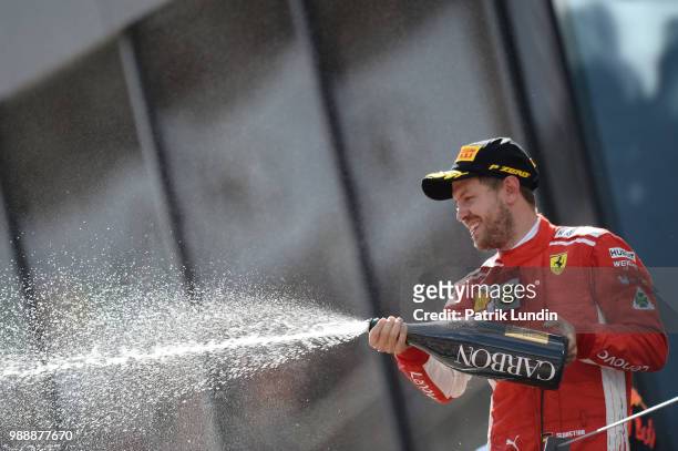 Third place finisher Sebastian Vettel of Germany and Ferrari celebrates on the podium during the Formula One Grand Prix of Austria at Red Bull Ring...