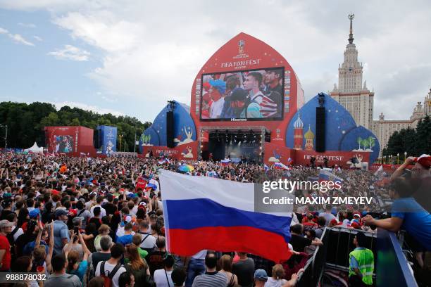 Fans watch a live telecast of the Russia 2018 World Cup round of 16 football match between Spain and Russia at the FIFA Fan Fest in Moscow on July 1,...