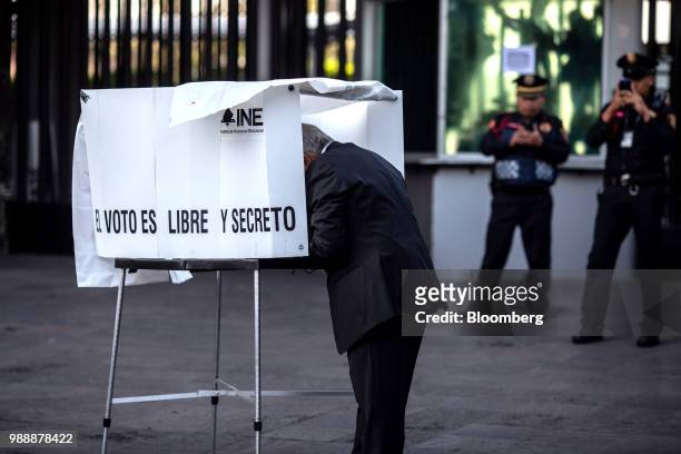Andres Manuel Lopez Obrador, presidential candidate of the National Regeneration Movement Party , marks a ballot at a polling station in the Copilco...