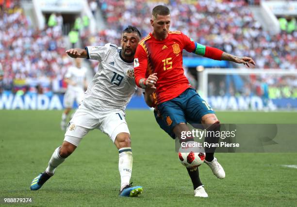 Alexander Samedov of Russia and Sergio Ramos of Spain battle for the ball during the 2018 FIFA World Cup Russia Round of 16 match between Spain and...