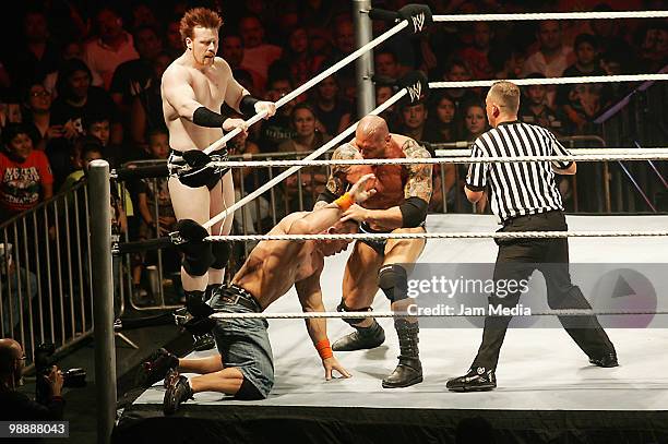 Wrestling fighters Sheanus , John Cena and Batista fight during the WWE RAW wrestling function at Arena Monterrey on May 5, 2010 in Monterrey, Mexico.