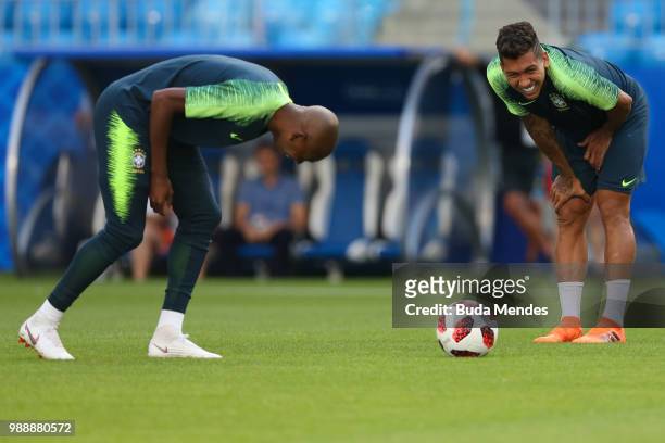 Fernandinho and Roberto Firmino smile during a Brazil training session ahead of the Round 16 match against Mexico at Samara Arena on July 1, 2018 in...