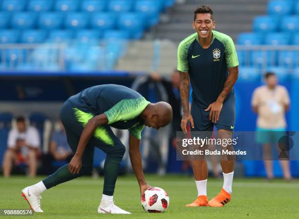 Fernandinho and Roberto Firmino smile during a Brazil training session ahead of the Round 16 match against Mexico at Samara Arena on July 1, 2018 in...