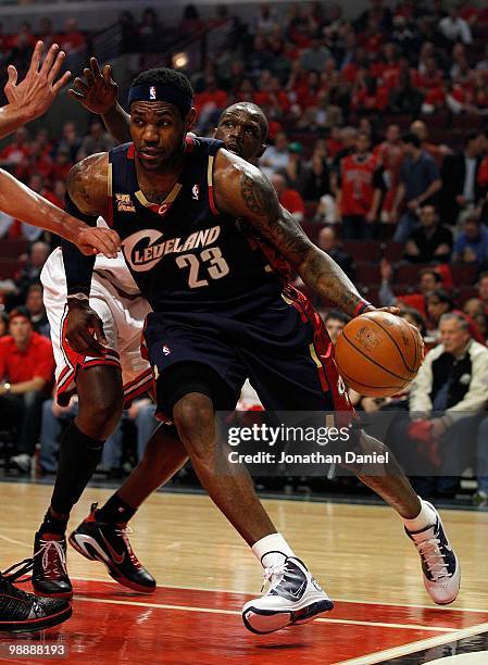 LeBron James of the Cleveland Cavaliers drives past Luol Deng of the Chicago Bulls in Game Three of the Eastern Conference Quarterfinals during the...