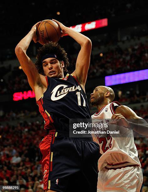 Anderson Varejao of the Cleveland Cavaliers grabs a rebound over Taj Gibson of the Chicago Bulls in Game Three of the Eastern Conference...