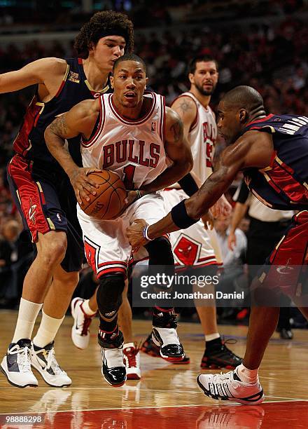 Derrick Rose of the Chicago Bulls moves against Anderson Varejao and Antawn Jamison of the Cleveland Cavaliers in Game Three of the Eastern...