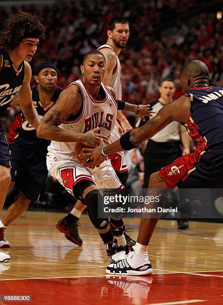 Derrick Rose of the Chicago Bulls moves against Anderson Varejao and Antawn Jamison of the Cleveland Cavaliers in Game Three of the Eastern...