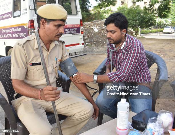 Police personnel attends a health camp held during a Raahgiri Day, an event organised by MCG at Sector 55 Golf Course Road, in Gurugram, India on...