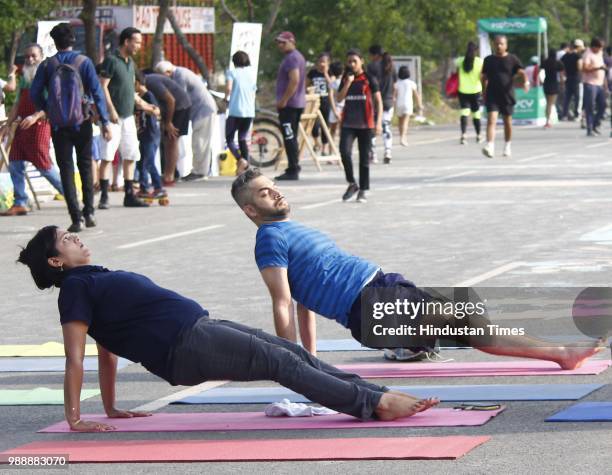 People seen performing yoga during a Raahgiri Day, an event organised by MCG at Sector 55 Golf Course Road, in Gurugram, India on Sunday, July 01,...
