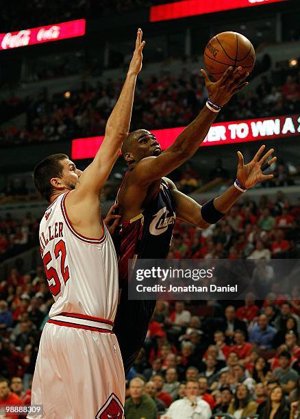 Antawn Jamison of the Cleveland Cavaliers puts up a shot around Brad Miller of the Chicago Bulls in Game Three of the Eastern Conference...