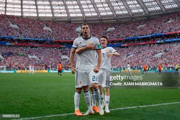 Russia's forward Artem Dzyuba celebrates after shooting a penalty kick and score a goal during the Russia 2018 World Cup round of 16 football match...