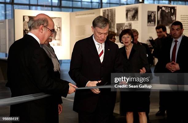 German President Horst Koehler cuts through a ceremonial ribbon as Rabbi Andreas Nachama , Director of the Topography of Terror documentation center...