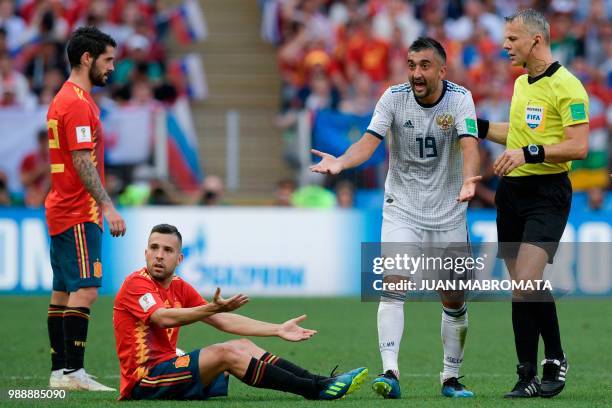 Spain's defender Jordi Alba and Russia's midfielder Alexander Samedov gesture between Spain's midfielder Isco and Dutch referee Bjorn Kuipers during...