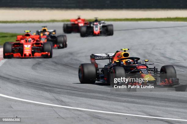 Max Verstappen of the Netherlands driving the Aston Martin Red Bull Racing RB14 TAG Heuer leads Kimi Raikkonen of Finland driving the Scuderia...