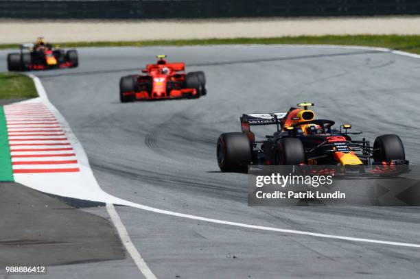 Max Verstappen of the Netherlands driving the Aston Martin Red Bull Racing RB14 TAG Heuer leads Kimi Raikkonen of Finland driving the Scuderia...