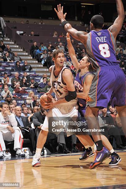 Brook Lopez of the New Jersey Nets looks to pass the ball against Steve Nash of the Phoenix Suns during the game on March 31, 2010 at the Izod Center...