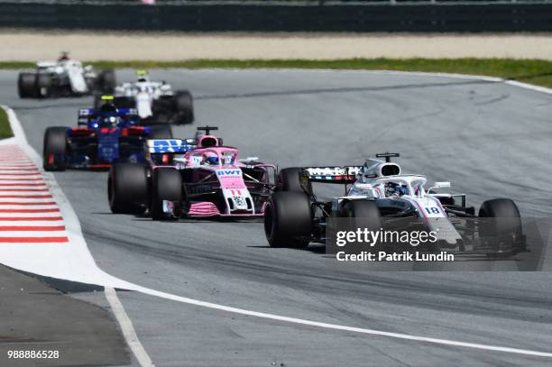 Lance Stroll of Canada driving the Williams Martini Racing FW41 Mercedes leads Sergio Perez of Mexico driving the Sahara Force India F1 Team VJM11...