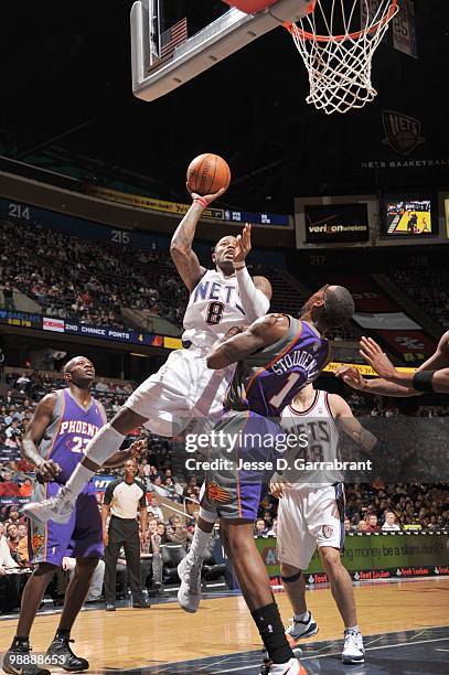 Terrence Williams of the New Jersey Nets puts a shot up against Amar'e Stoudemire of the Phoenix Suns during the game on March 31, 2010 at the Izod...