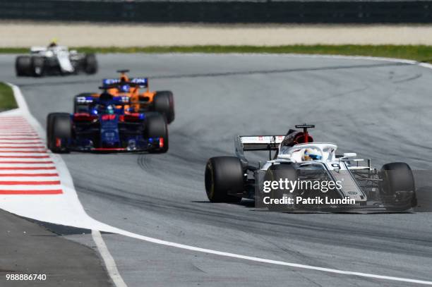 Marcus Ericsson of Sweden driving the Alfa Romeo Sauber F1 Team C37 Ferrari leads Brendon Hartley of New Zealand driving the Scuderia Toro Rosso...