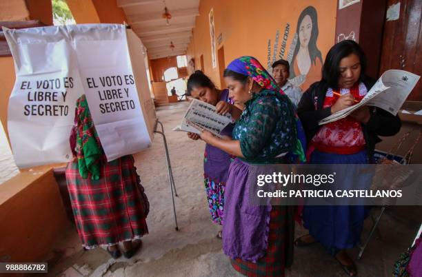 Zapoteca ethnic group woman casts her vote during general election, in San Bartolome Quialana, Oaxaca State, Mexico on July 1, 2018. Mexicans go to...