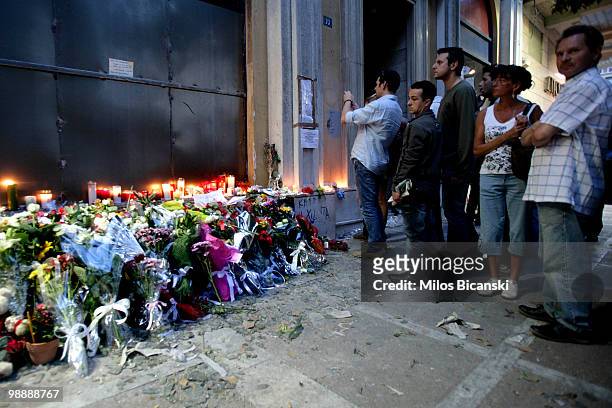 People queue to pay their respects in front of the Marfin Egnatia bank branch where three people were killed during demonstrations on May 6, 2010 in...