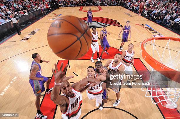 Dante Cunningham of the Portland Trail Blazers go up for a shot as teammate Brandon Roy defends against Amare Stoudemire of the Phoenix Suns in Game...