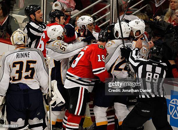 Members of the Chicago Blackhawks including Dave Bolland and Jonathan Toews fight with members of the Nashville Predators including Francis Bouillon...