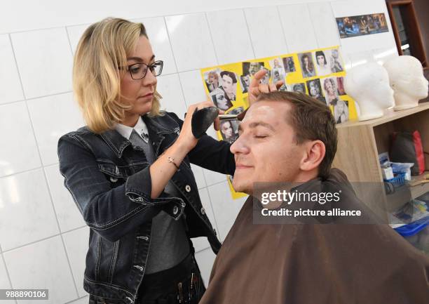 June 2018, Germany, Zinnowitz: Western Pomerania state secretary Patrick Dahlemann is fitted with a wig for a guest role in the make-up room of...